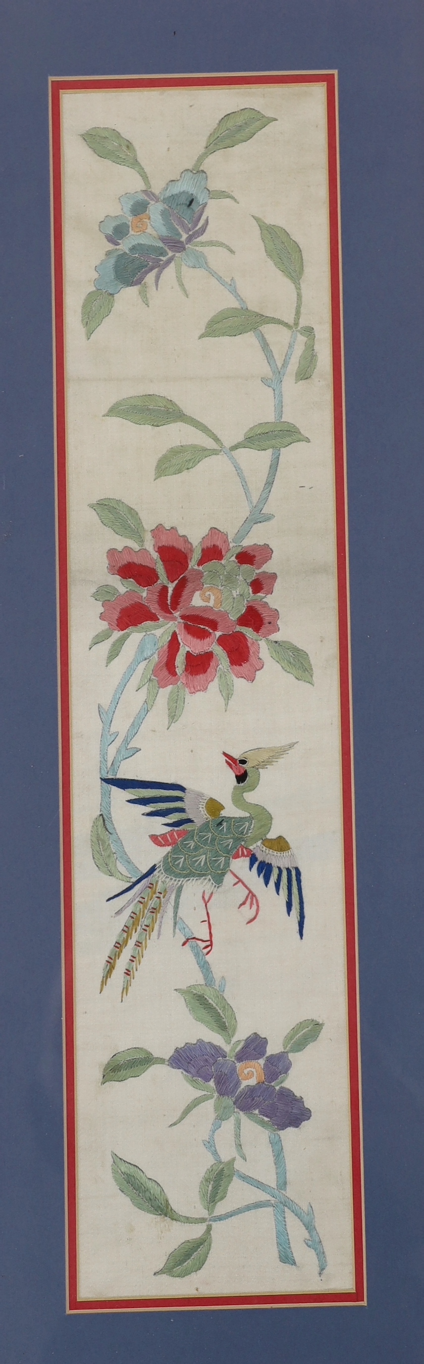 A pair of framed early 20th century Chinese cream silk polychrome silk embroidered sleeve bands, 11cm wide x 49cm long not including mount or frame